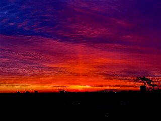 Minsk, Belarus, December 28, 2023. Spectacular sunrise. A light pillar is an atmospheric optical phenomenon in which a vertical beam of light appears to extend above andor below a light source.