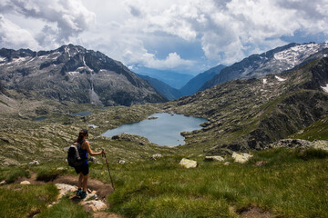 Fototapeta na wymiar Young hiker girl summit to Montardo Peak in AIguestortes and Sant Maurici National Park, Spain