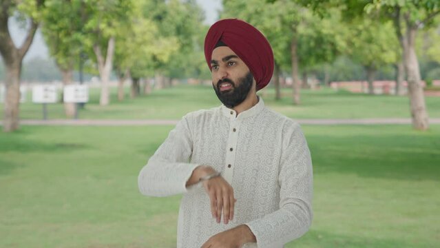 Frustrated Sikh Indian man flying a mosquito in park