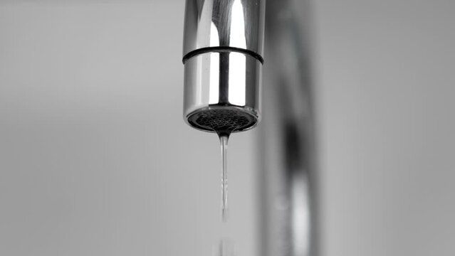 Dripping water faucet or kitchen tap. Shortage and conservation of natural resources concept