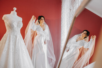 portrait of a luxurious bride in boudoir style near a mirror with reflection. Preparing the bride...