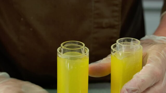 Glass molds stuffed with delightful combination of juice and spices. Gelatin content solidifies liquid resulting in cylinder