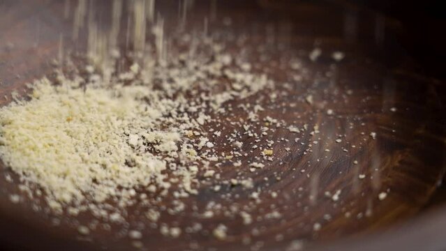 Sprinkling almond flour into a wooden bowl. Low glycemic index product. Healthy Gluten Free Vegan Dietary Ingredient. Slow motion. Rotation