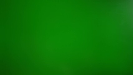 A man shows a what-you-want gesture with his hand on a green background