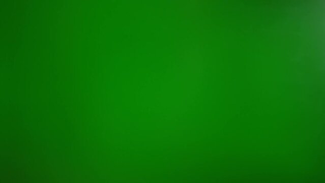 A man shows a "so-so" gesture with his hand on a green background