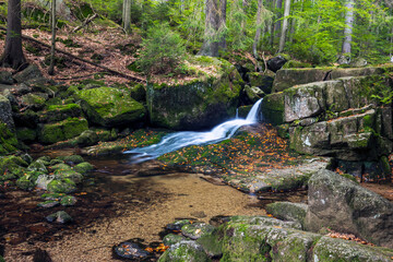 Waterfall in the forest. Autumn landscape with beautiful waterfall in the forest.