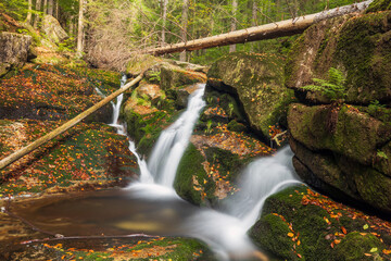 Waterfall in the forest. Autumn landscape with beautiful waterfall in the forest.