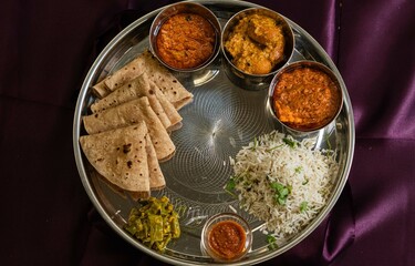 Vegetarian Indian thali, Indian home food with lentil dal, paneer, roti, rice, curd and chutney, Hindu Veg Thali, Indian Food Thali Top View.