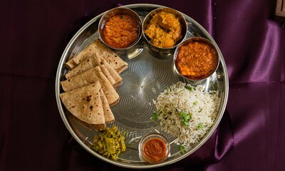 Vegetarian Indian thali, Indian home food with lentil dal, paneer, roti, rice, curd and chutney,...