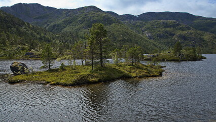 Islands on the lake Nedre Karingsvatnet at Gronelva in Nordland county, Norway, Europe
