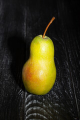 single pear on wood background