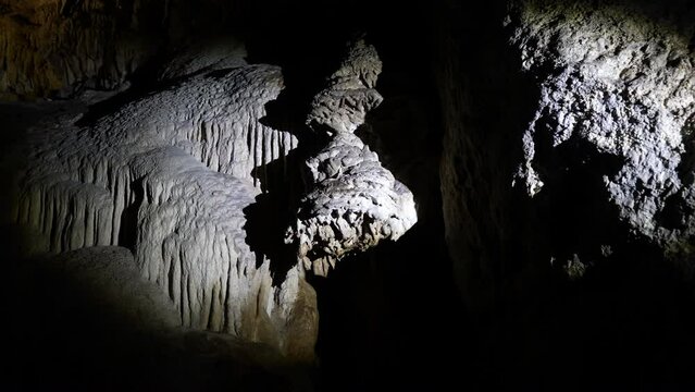 Point of view from floating ship to Grotta dello Smeraldo just outside Amalfi, natural highlight along Amalfi Coast. Light from flashlight brightens dark interior of cave. Shooting in slow motion.