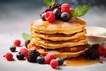 Berries maple syrup and pancakes for breakfast