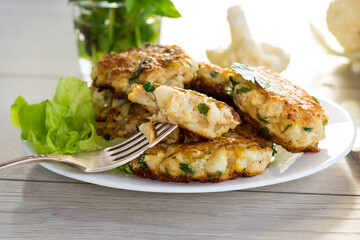 cooked vegetarian fried cauliflower cutlets in a plate