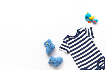 Flat lay of blue baby clothing and accessories. Kids bodysuit and shoes flat lay