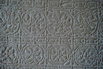 Ancient asian stone wall with flower ornaments in Cambodia Angkor Wat Siem Reap for pattern background 