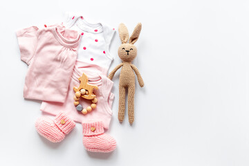 Flat lay of pink baby clothing and accessories. Kids bodysuit and shoes flat lay