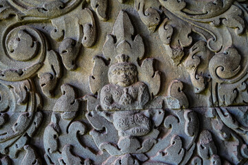Ancient asian stone wall with human and flower ornaments in Cambodia Angkor Wat Siem Reap for...