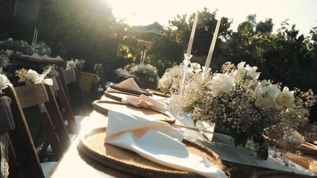 Wedding day event organization table setting decor luxury event. Wedding Decor. A large number of brown wooden chairs are lined up against the backdrop of the wedding decor. 