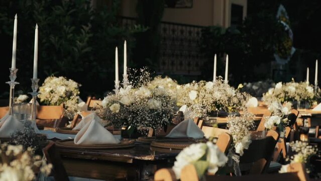Wedding day event organization table setting decor luxury event. Wedding Decor. A large number of brown wooden chairs are lined up against the backdrop of the wedding decor. 