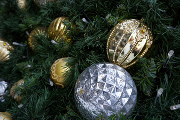 Closeup of a Snow Vinyl Christmas Tree decorated with silver and gold color balls