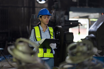 Female factory worker working in industry factory area. Worker and manufacturing industry factory...