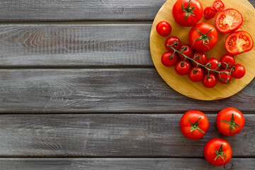 Cooking background with tomatoes and basil on wooden board