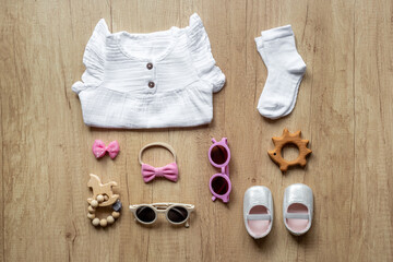 Set of baby girl dress and accessories, top view. Kids wear flat lay