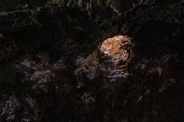 Interior of the cave of Los Jameos del Agua. Light at the end of the cave. Lanzarote, Canary...