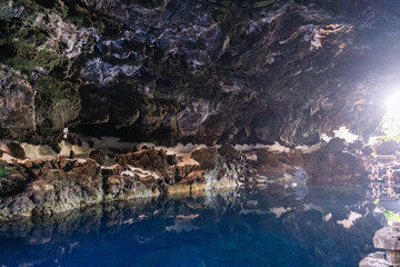 Interior of the cave of Los Jameos del Agua. Light at the end of the cave. Lanzarote, Canary Islands, Spain.