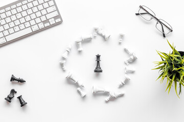 Business strategy concept. Chess pieces on office table, top view