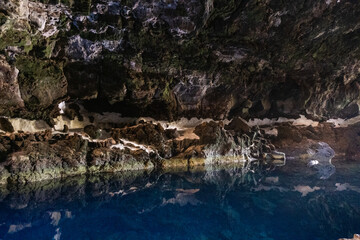 Interior of the cave of Los Jameos del Agua. Light at the end of the cave. Lanzarote, Canary Islands, Spain.
