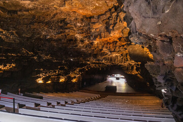 Interior of the auditorium of Los Jameos del Agua. Cave rock wall. Lighting in the rock wall of the cave. Lanzarote, Canary Islands, Spain.