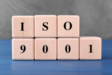 International Organization for Standardization. Cubes with abbreviation ISO and number 9001 on blue...