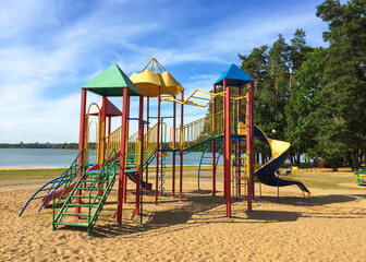 Children's Outdoor Playground Equipment with Slides and Ladders in Park.