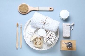 Bath accessories. Flat lay composition with personal care products on light blue background