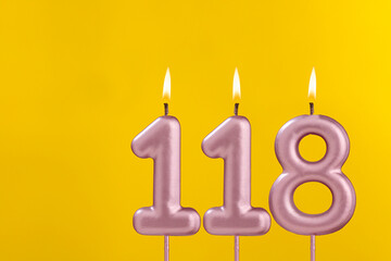 Birthday candle number 118 - Birthday celebration on yellow background