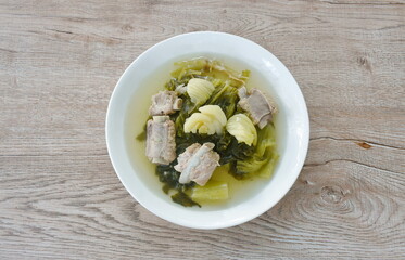 boiled pickled cabbage with pork bone in clear soup on plate