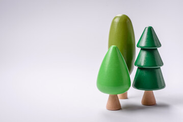 Wooden model of a tree with a green crown and trunk on a white background