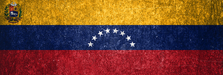 Close-up of the grunge Venezuela flag. Dirty flag of Venezuela on a metal surface.