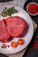 Fresh juicy raw filet mignon with salt, spices and herbs