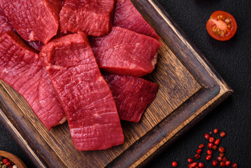 Juicy fresh raw beef meat with salt, spices and herbs