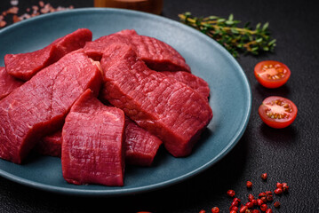 Juicy fresh raw beef meat with salt, spices and herbs