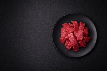 Juicy fresh raw beef meat with salt, spices and herbs