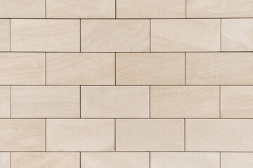 brick wall made of light beige bricks. fresh brickwork, house decoration, new brick wall texture