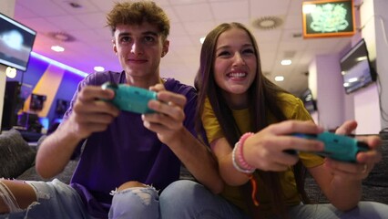 two brothers playing the game console while having fun and making jokes