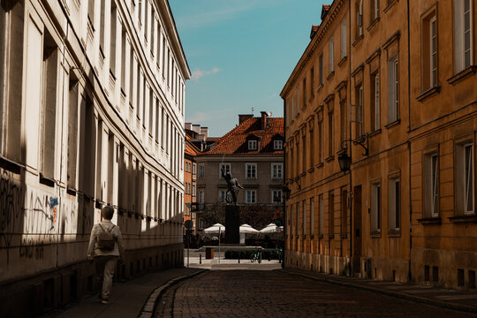 old street in Warsaw Poland dark shadows in a sunny day windows simetrical