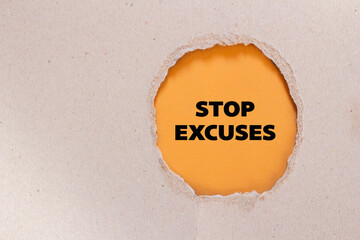 Stop excuses lettering on ripped paper with orange background. Conceptual business photo. Top view,...