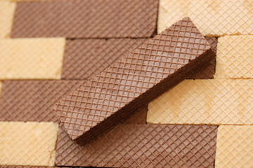 Stacked delicious chocolate wafers in large amount. Two different flavours of classic small waffles