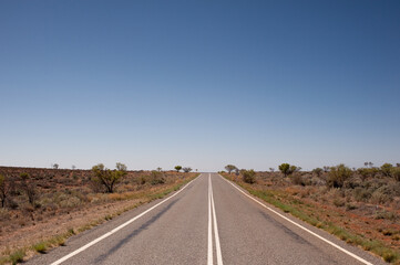 Fototapeta na wymiar Highway running through the Australian Outback, Near Broken Hill, NSW.